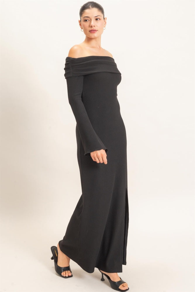 woman wearing a black off-the-shoulder long sleeve maxi dress with a side slit and ribbed texture