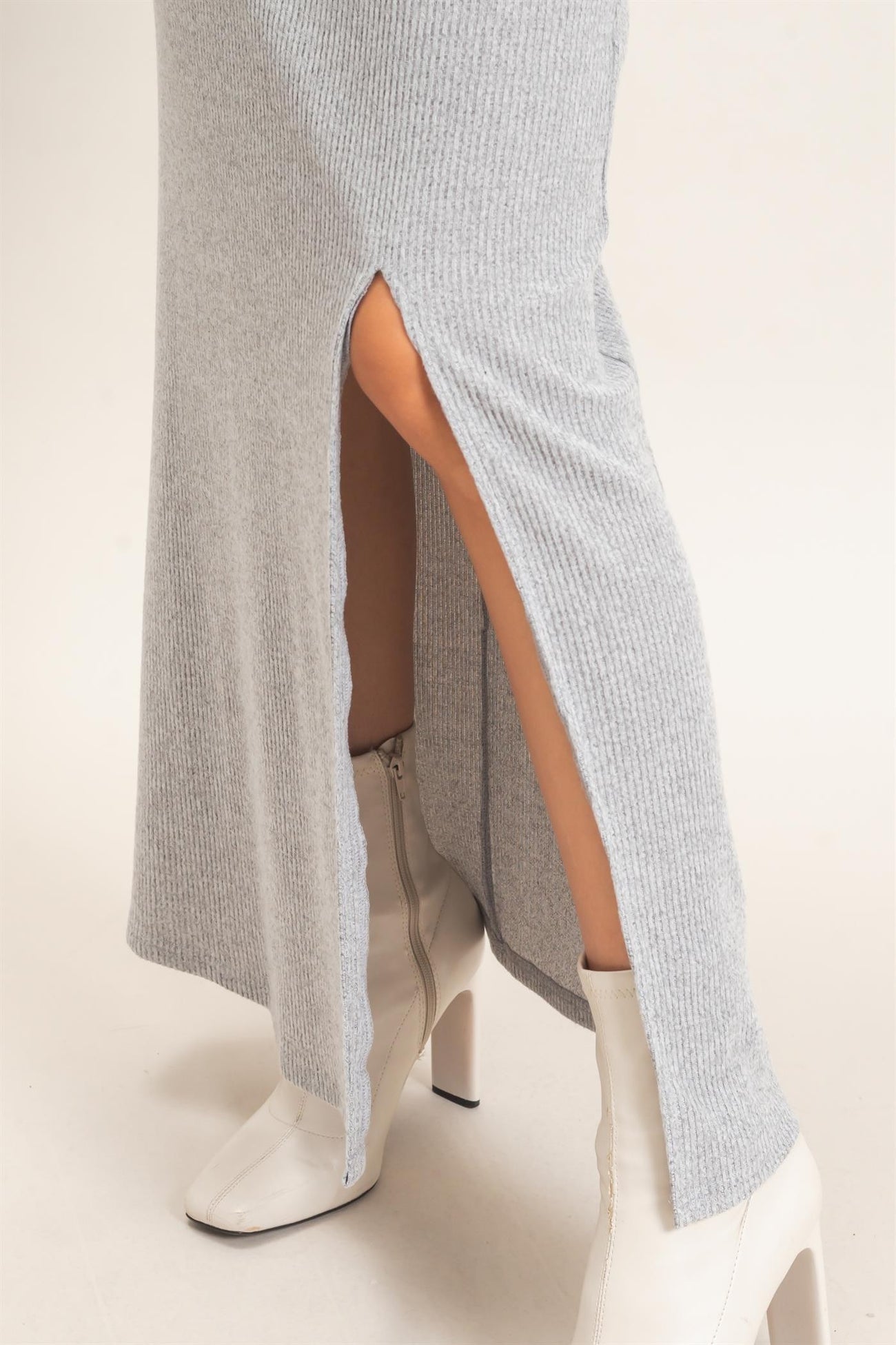 gray ribbed maxi dress with side slits, paired with white ankle boots