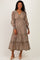 woman wearing a brown floral print maternity maxi dress with long sleeves and a tiered skirt, showcasing her baby bump