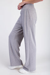 woman wearing light gray wide-leg lounge pants with a relaxed fit and elastic waistband