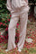 woman wearing light pink wide-leg lounge pants with an elastic waistband and side pockets