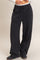 woman wearing black wide-leg lounge pants with an elastic waistband and side pockets