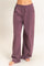 woman wearing loose-fitting lavender sweatpants with an elastic waistband and side pockets