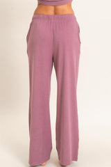 woman wearing relaxed fit light pink wide-leg lounge pants with pockets