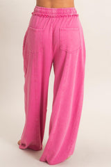 pink wide leg pants with elastic waistband and large back pockets, model shown from the back