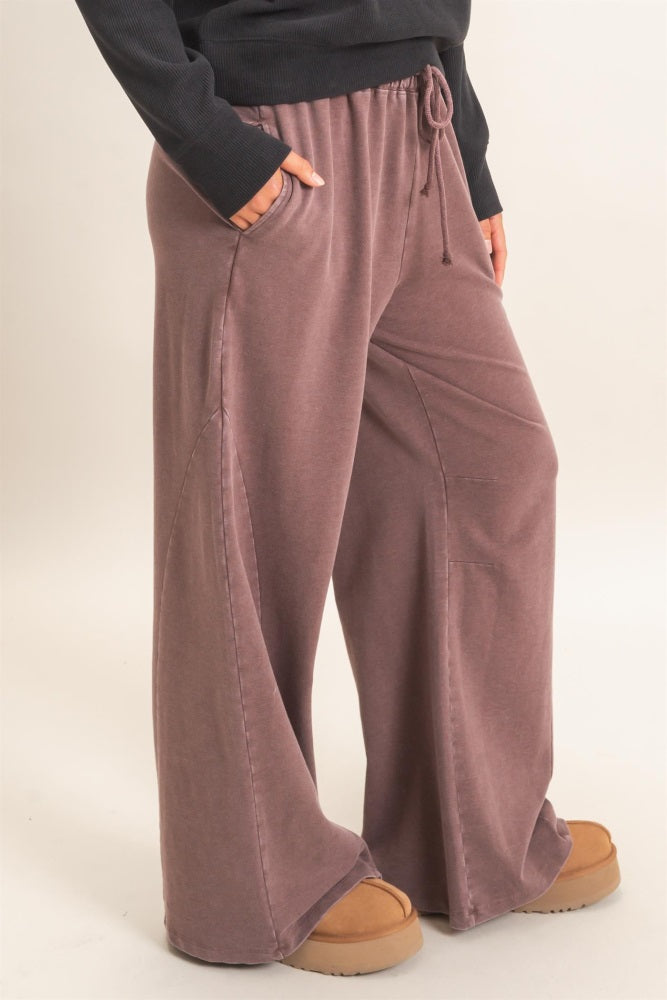 woman wearing mauve wide-leg lounge pants with pockets and a drawstring waist