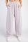 woman wearing light gray wide-leg sweatpants with side pockets and an elastic waistband