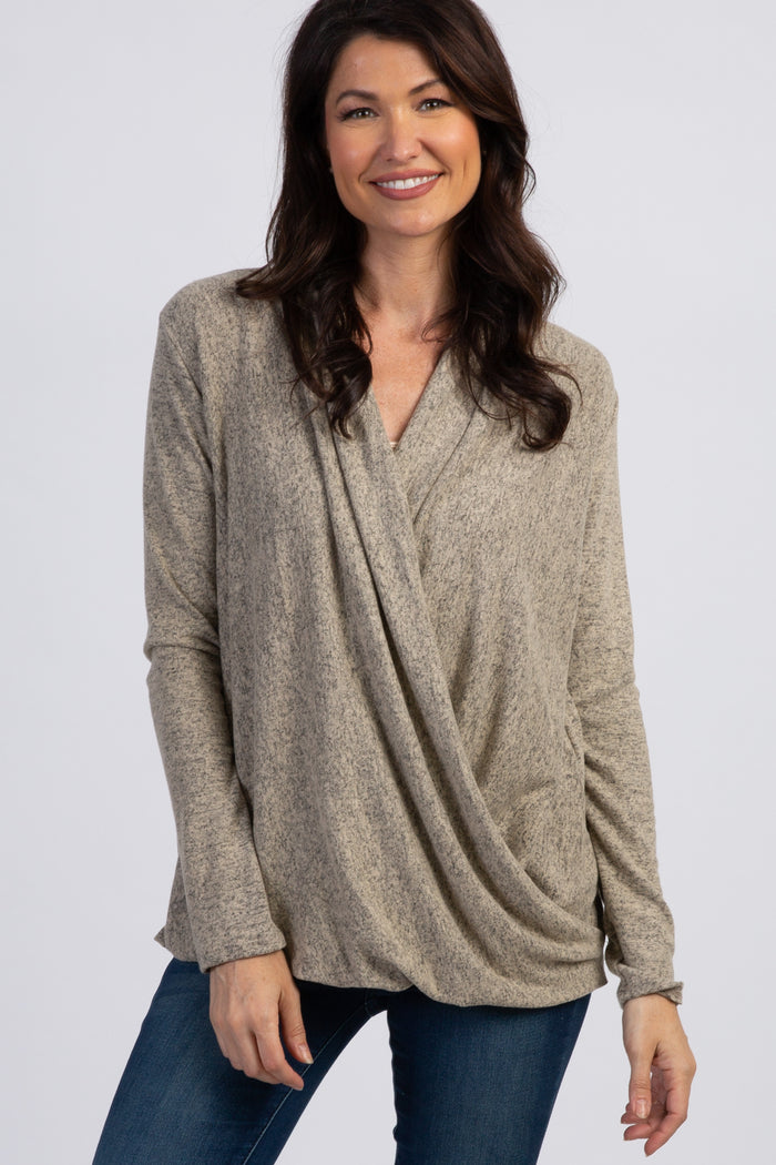 woman wearing a taupe cross-front long sleeve top with a relaxed fit and a stylish draped design