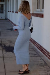 woman wearing a light blue ribbed knit maxi dress with a v-neck and long sleeves, walking outdoors