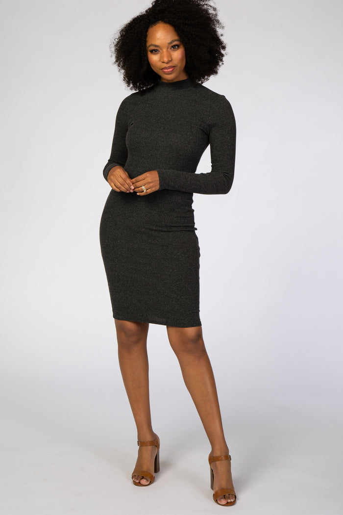 woman wearing a dark gray long sleeve bodycon dress and tan strappy heels