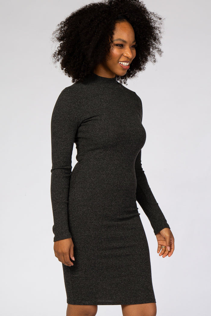 woman with curly hair wearing a charcoal grey long sleeve mock neck ribbed knit dress