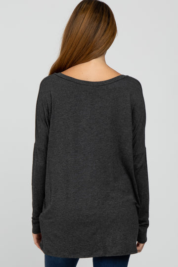 woman wearing a dark gray long sleeve maternity top, viewed from the back