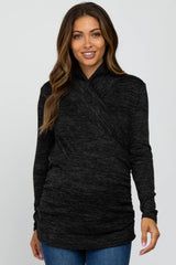 woman wearing a dark grey maternity wrap top with a ruched hem and long sleeves