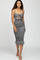 woman wearing a black and white striped midi dress with a tie-front top and ruffled hem detail