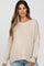 woman wearing a beige oversized knit maternity sweater with a relaxed fit and wide neckline