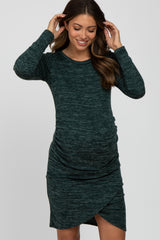 woman wearing a dark green long sleeve maternity dress with a ruched side and a visible baby bump