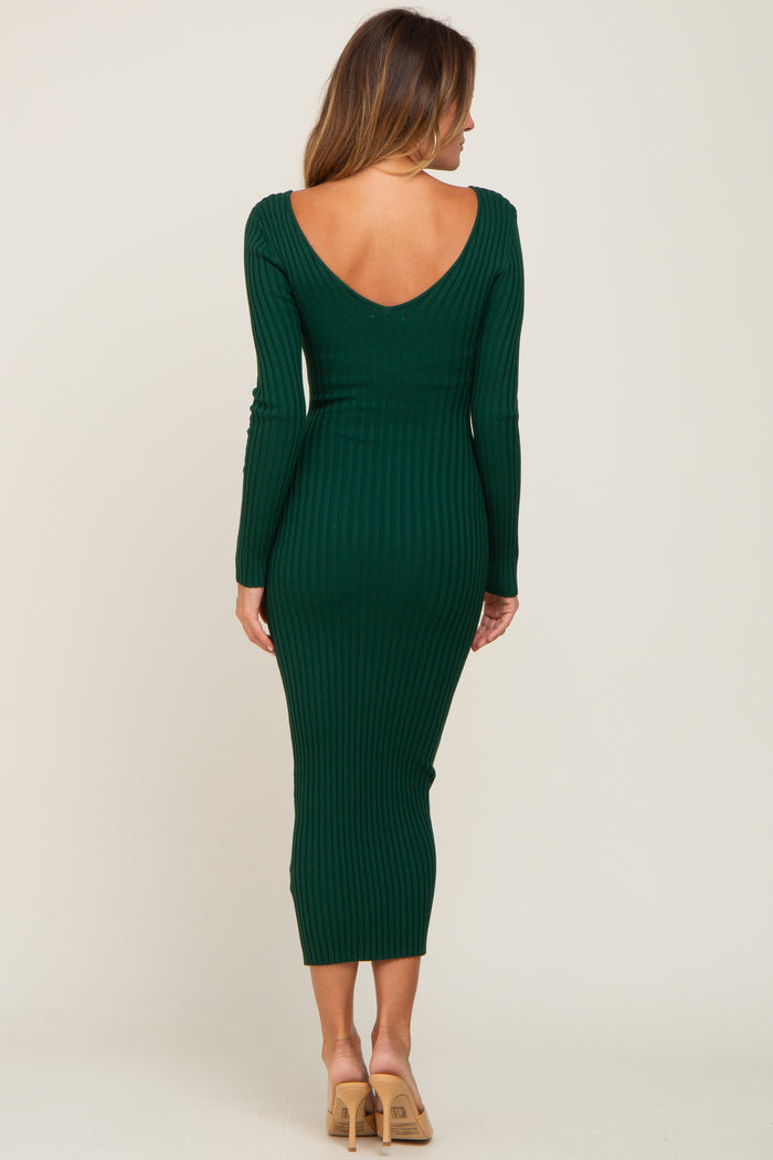 woman wearing a dark green ribbed midi dress with a deep v-back and long sleeves