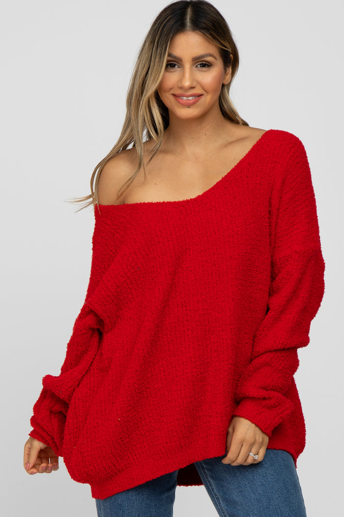 woman wearing a red oversized off-the-shoulder sweater with long sleeves and a relaxed fit