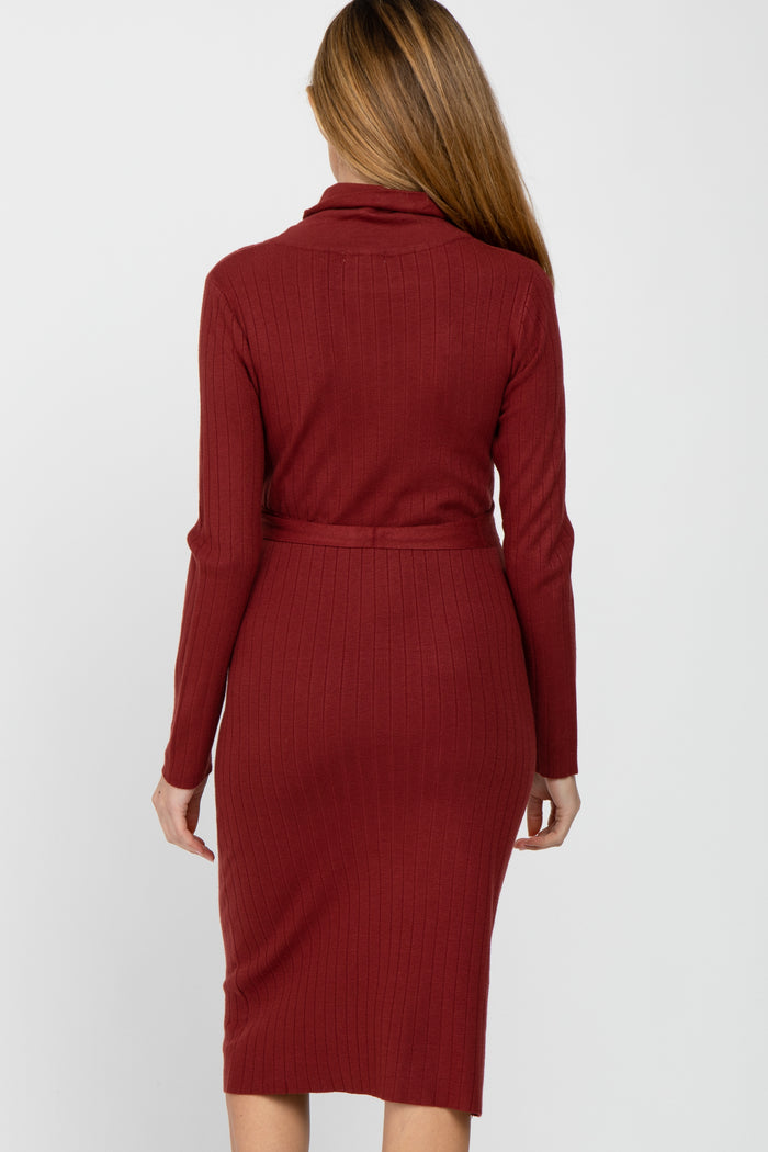 Back view of a woman wearing a long-sleeved ribbed knit midi dress in burgundy with a matching waist tie