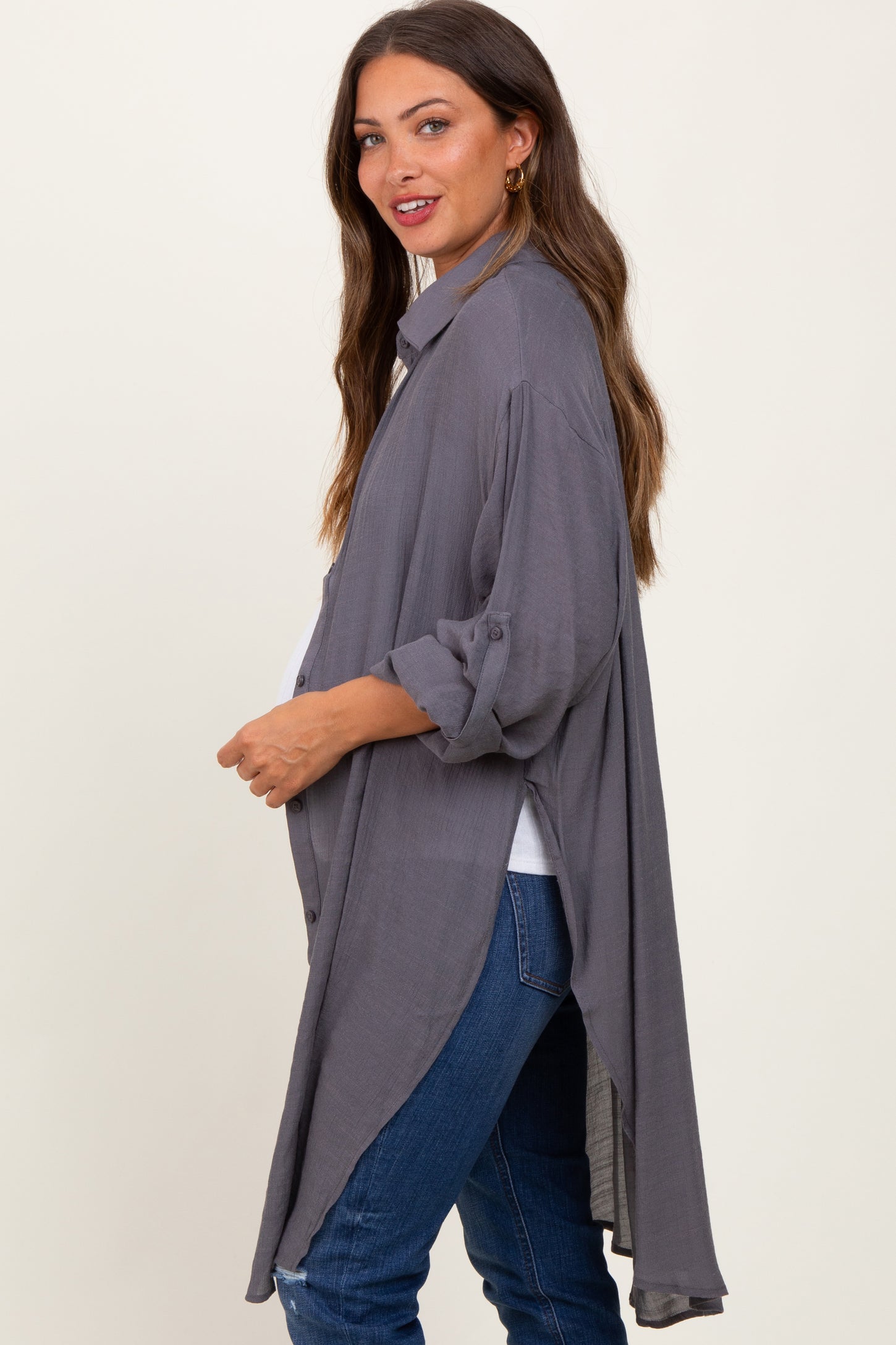 woman wearing a gray long maternity cardigan with rolled sleeves and a high-low hemline