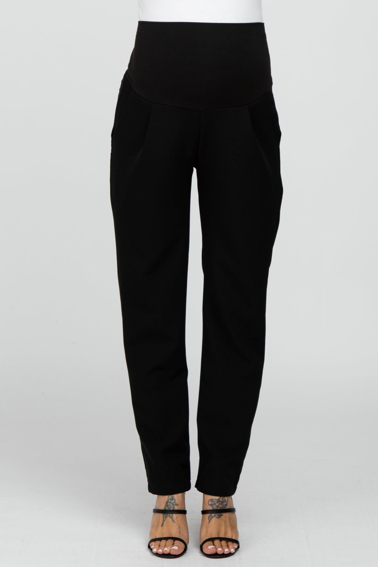 woman wearing black maternity joggers with a wide waistband and pockets