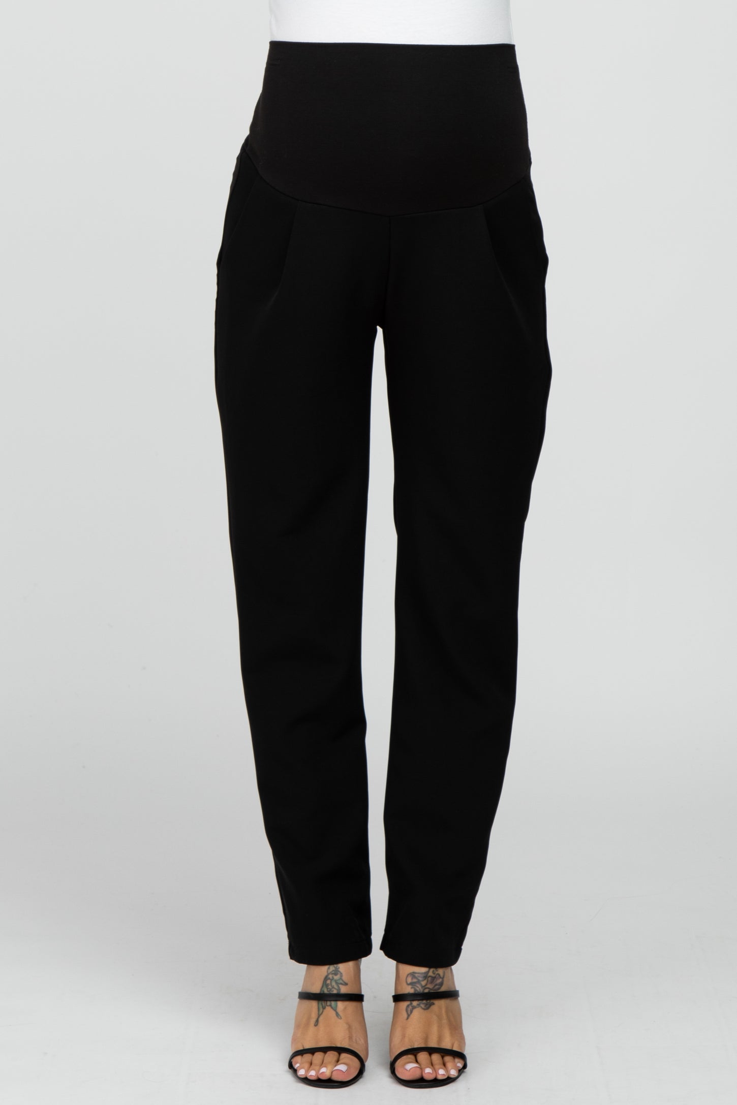 woman wearing black maternity joggers with a wide waistband and pockets
