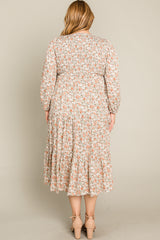 woman wearing a floral patterned plus-size midi dress with long sleeves and a tiered skirt, view from the back
