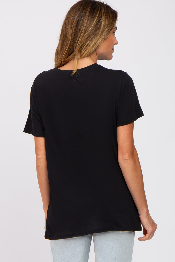 woman wearing a black short sleeve t-shirt from the back, paired with light blue denim jeans