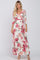 woman wearing a floral print wrap maxi dress with three-quarter sleeves and a tie at the waist