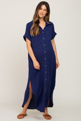 woman wearing a navy blue short sleeve button-up maternity dress with side slits and a front pocket