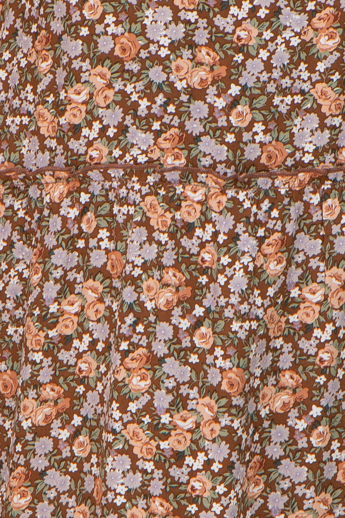 brown floral dress with a tiered design featuring pink and purple flowers