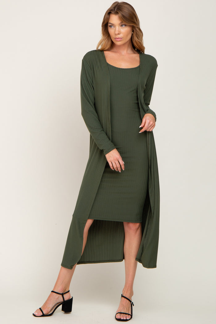 woman wearing olive green ribbed midi dress and matching long cardigan with black heels