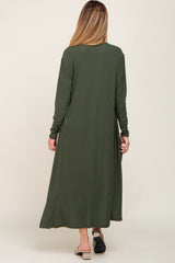 woman wearing a long olive green ribbed maternity dress, shown from the back