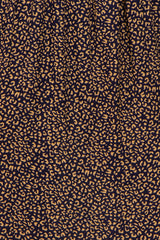 navy blue fabric with a tan abstract leopard print pattern