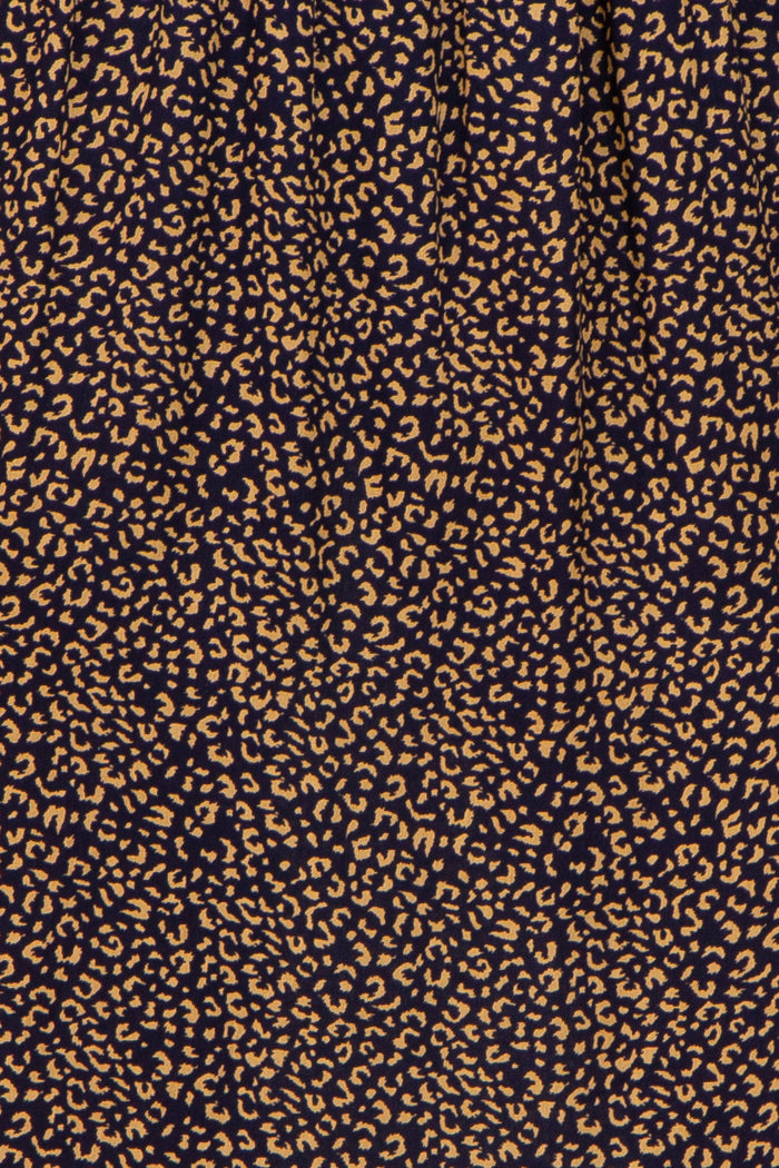 navy blue fabric with a tan abstract leopard print pattern