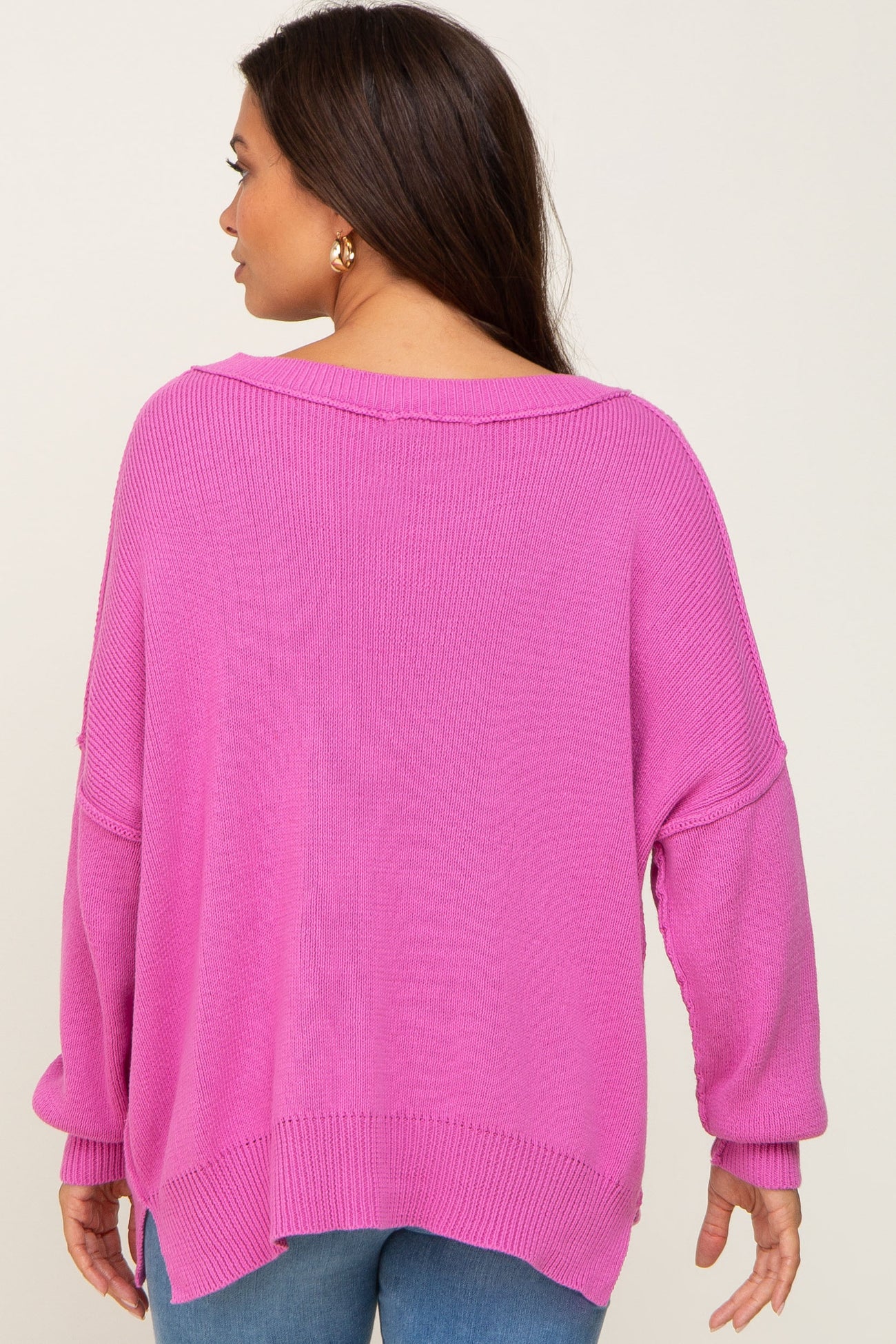 woman wearing a lavender oversized maternity sweater from the back with loose sleeves and a relaxed fit