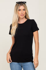 woman wearing a fitted black short sleeve t-shirt with a round neck and sunglasses on her head