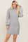 woman wearing a gray ribbed turtleneck mini dress with long sleeves