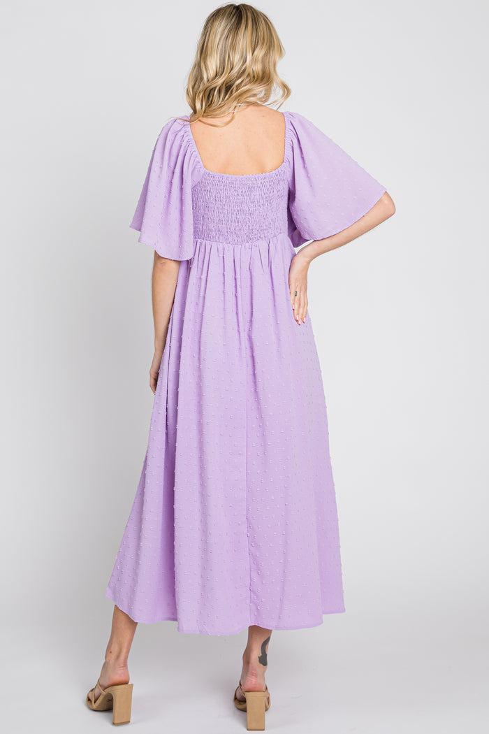 woman wearing a lavender smocked back maxi dress with flutter sleeves, seen from the back