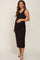 woman wearing a black ribbed maternity dress showing her baby bump