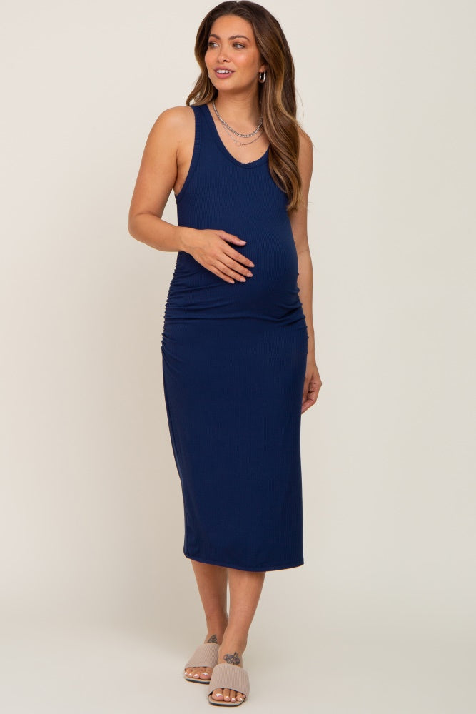 pregnant woman wearing a navy blue ribbed maternity midi dress with side ruching and tank top straps