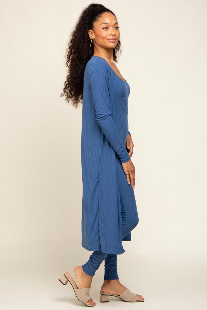 woman wearing a long sleeve blue ribbed maxi dress with side slits and paired with beige heeled sandals