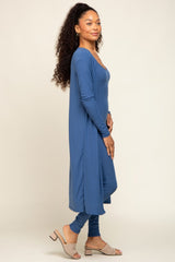 woman wearing a long sleeve blue ribbed maxi dress with side slits and paired with beige heeled sandals