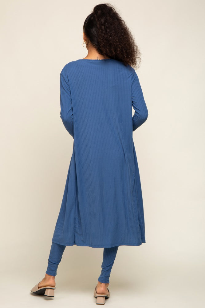 woman wearing a long blue ribbed tunic dress with a relaxed fit and paired with matching leggings