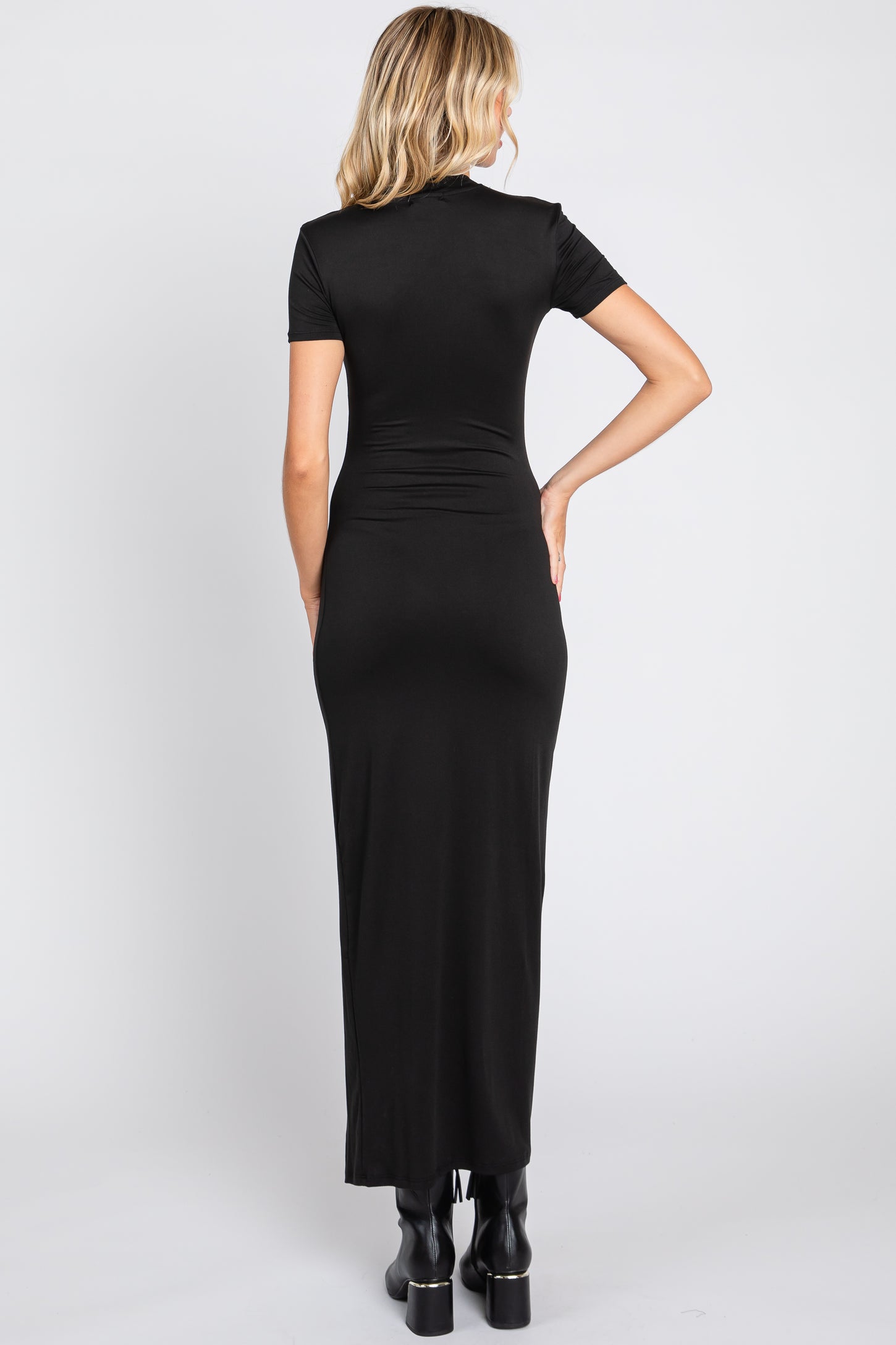woman wearing a fitted black maxi dress with short sleeves and a sleek silhouette, viewed from the back