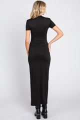woman wearing a fitted black maxi dress with short sleeves and a sleek silhouette, viewed from the back