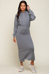 woman wearing a gray hoodie dress with long sleeves and a fitted skirt, styled casually with sneakers