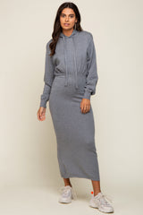 woman wearing a gray hooded long sleeve dress with a drawstring waist and white sneakers
