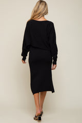 woman wearing a black maternity dress with a relaxed fit and long sleeves, showing a baby bump from the back