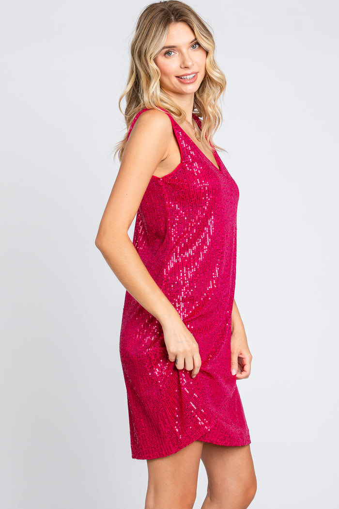 woman wearing a sleeveless hot pink sequin party dress with a relaxed fit